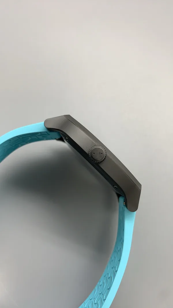 Élégante 48 mm replica, white dial, dark case, sky blue rubber strap