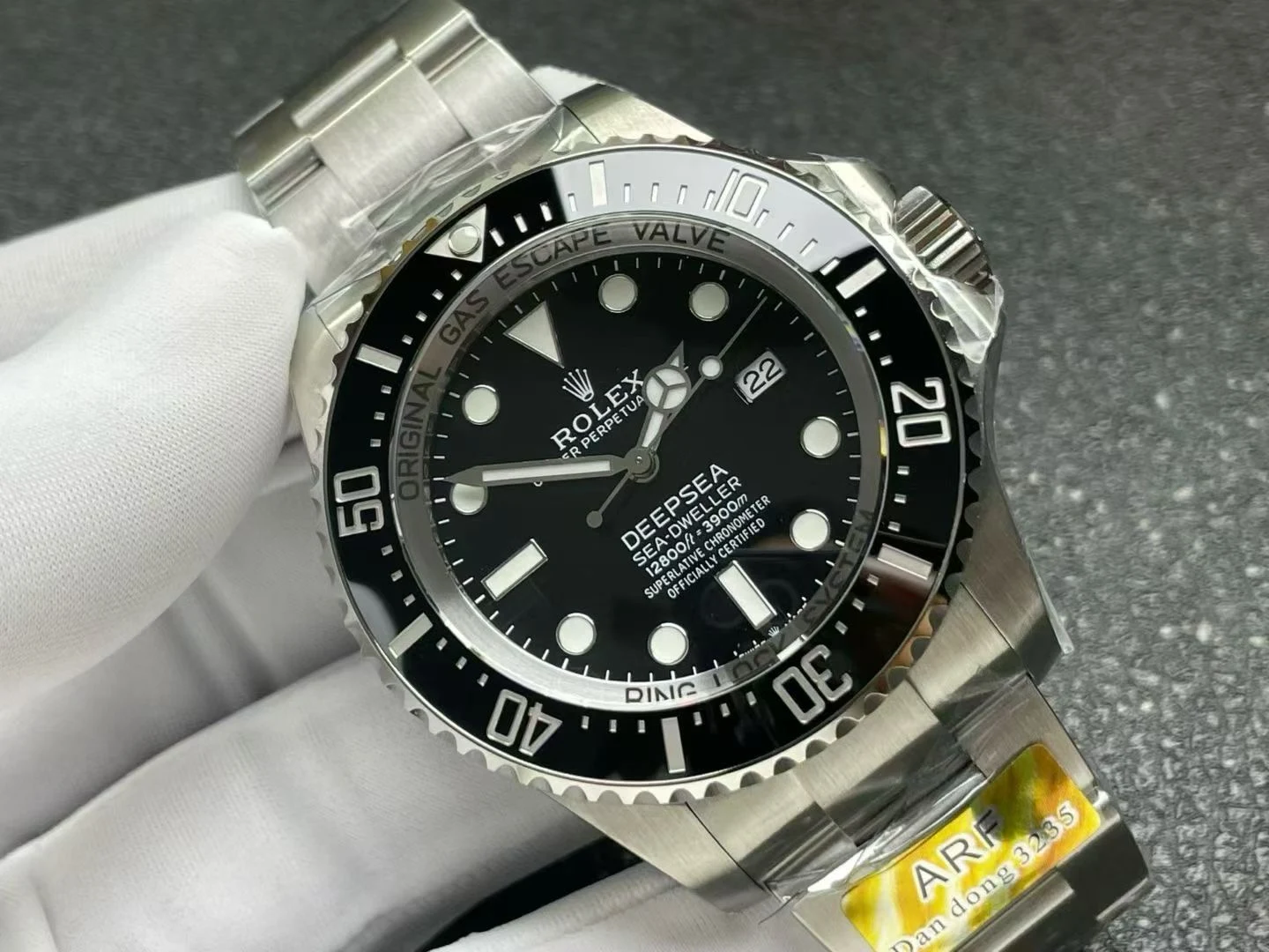 Black dial at an angle, catching the ceramic bezel and the inner ring text