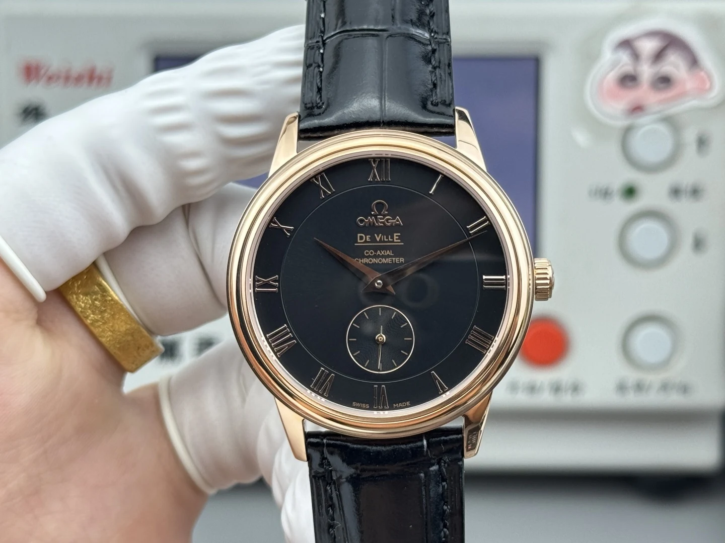 Black dial with gold-tone Roman numerals and small seconds, rose-gold-tone case, black alligator-pattern strap, front view