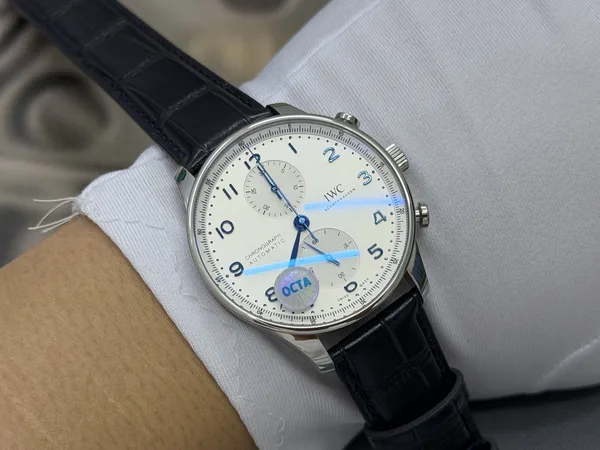 OCTA Portugieser Chronograph, silver dial with blue hands, black leather strap, on the wrist