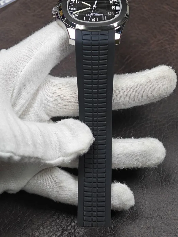 Watch on its black textured strap, dial at the top
