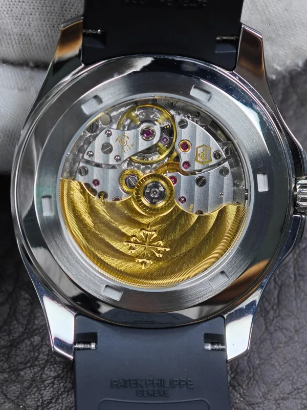 Display caseback showing the 26-330 clone movement and gold-tone rotor