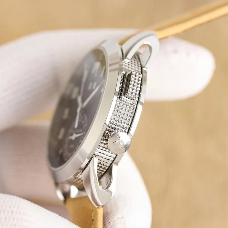 Black dial at an angle from the crown side, showing the hobnail caseband, the pusher, the crown and the skeletonised lugs