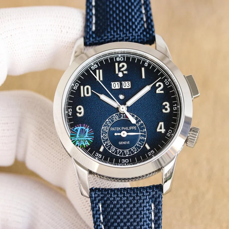 Blue dial, front view, on a blue fabric-pattern strap, with a hologram sticker on the crystal
