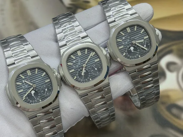 UMI Nautilus 5712/1A, blue-grey dial, steel bracelet, three examples, angled