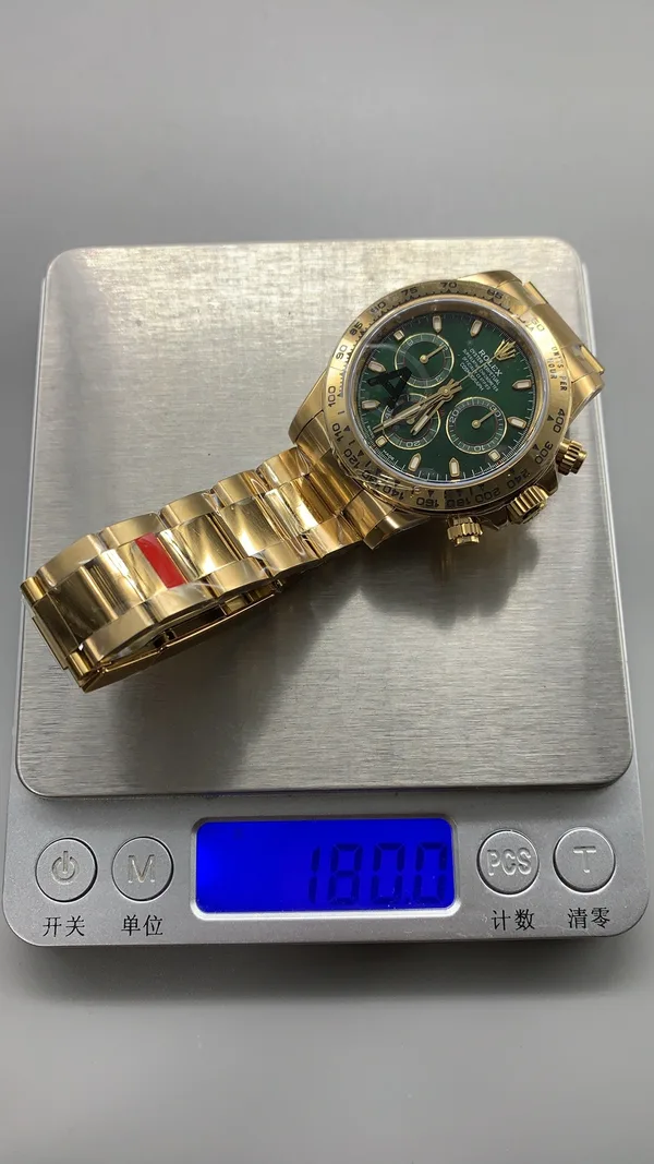 VSF Daytona 116508, green dial, yellow-gold-tone case, on a scale reading 180.0 g